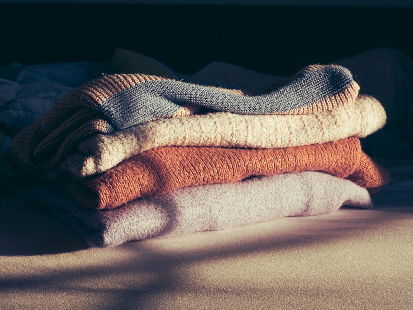 A stack of freshly folded towels in warm afternoon light